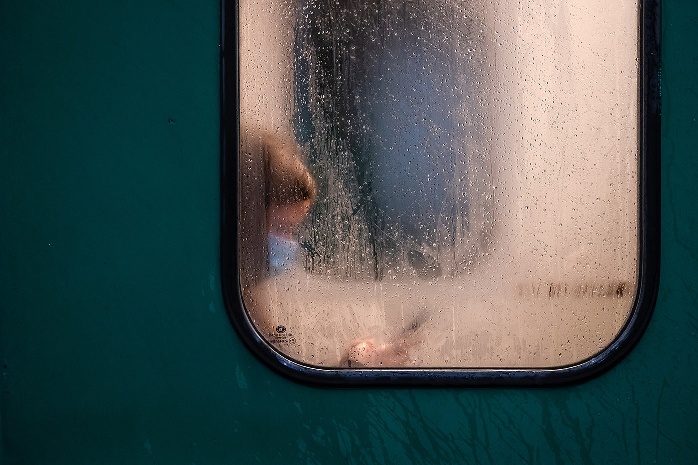 Mobile phone passenger on the HÉV on a rainy day #521