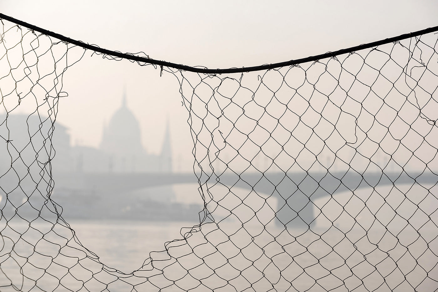 Budapest skyline through a wire fence #1875