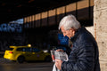 Reading the newspaper at Zugló train station #3376